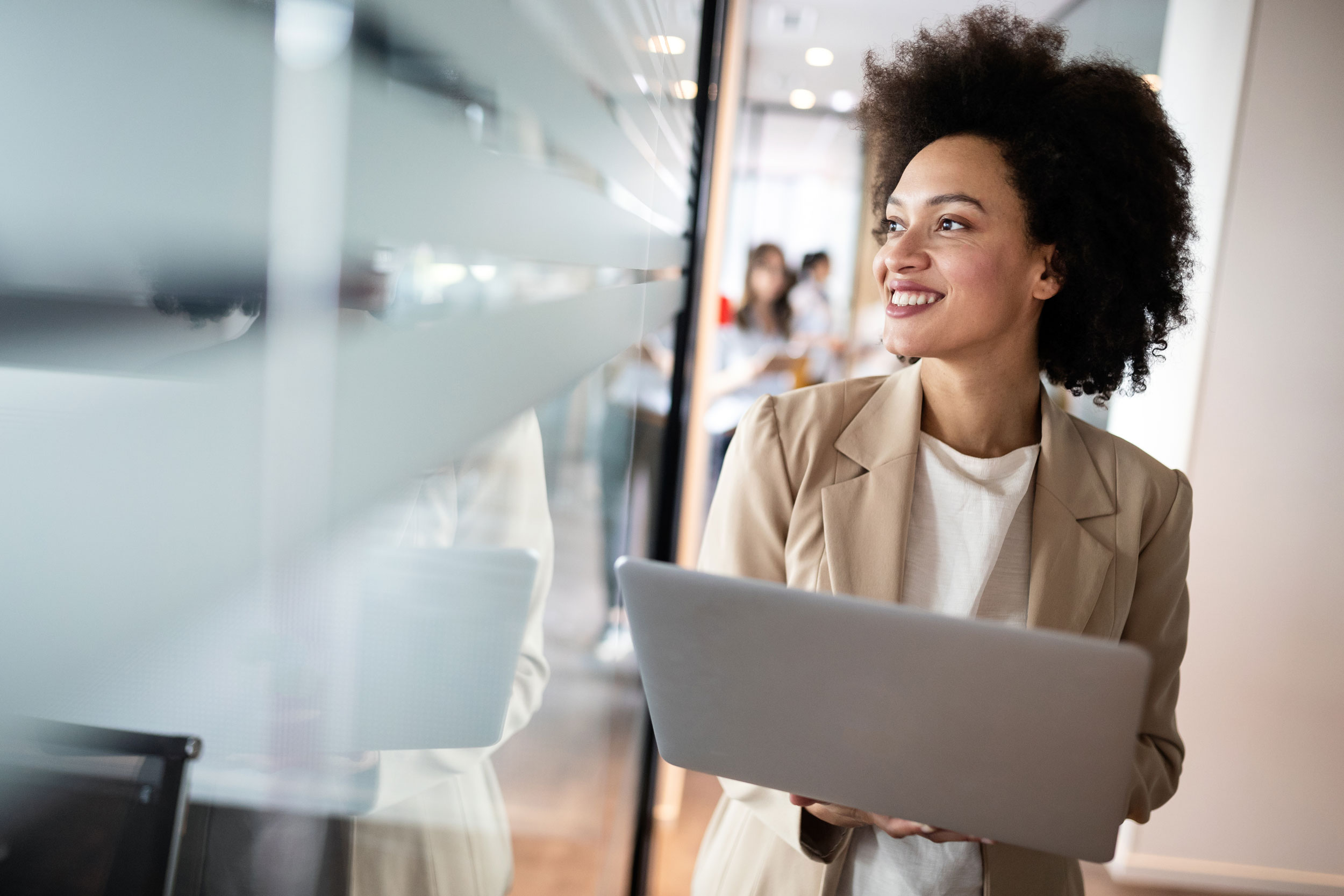 business-woman-smiling-holding-laptop